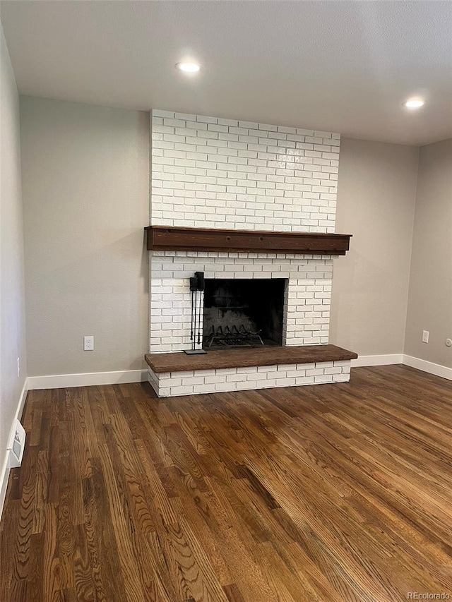 2836 S Fenton St, Denver, CO 80227 - unfurnished living room featuring wood finished floors, a fireplace, and recessed lighting