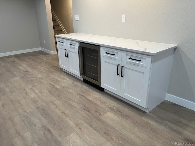 2836 S Fenton St, Denver, CO 80227 - indoor dry bar with wine cooler, light wood-type flooring, and stairway