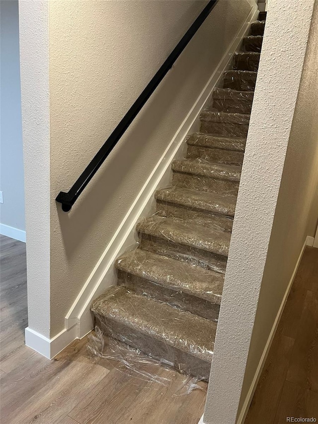 2836 S Fenton St, Denver, CO 80227 - stairs with wood finished floors and a textured wall