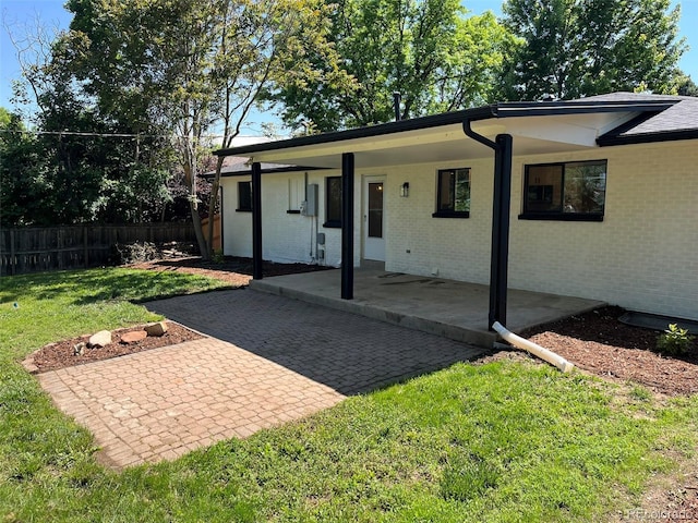 2836 S Fenton St, Denver, CO 80227 - view of front of property featuring brick siding and a patio
