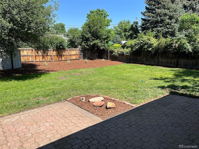 2836 S Fenton St, Denver, CO 80227 - fenced backyard with a patio and a storage shed