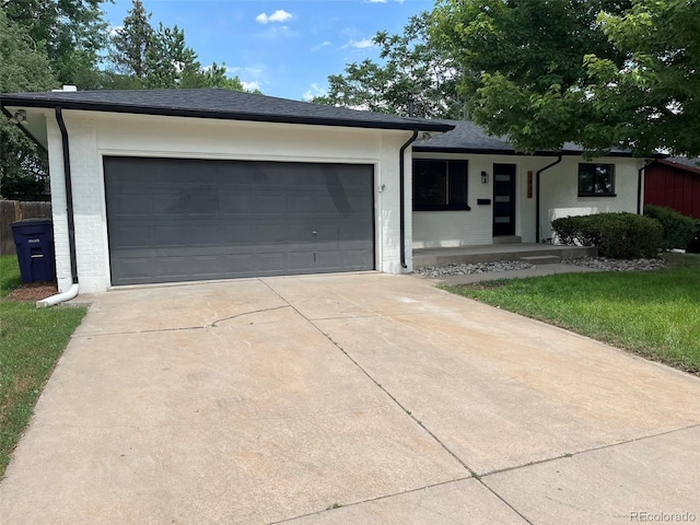 2836 S Fenton St, Denver, CO 80227 - single story home featuring driveway, a garage, covered porch, and brick siding