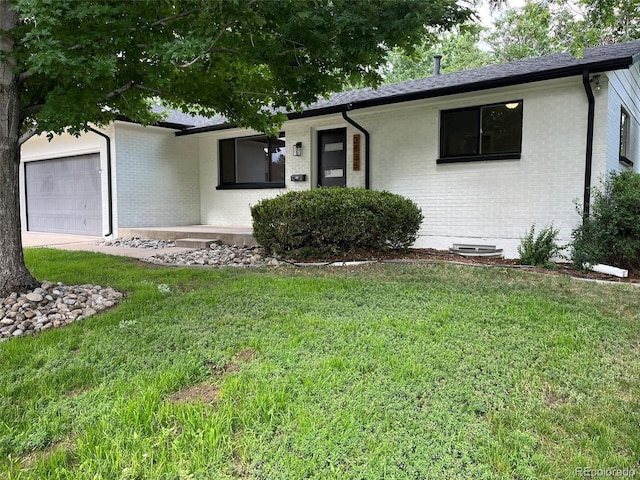 2836 S Fenton St, Denver, CO 80227 - ranch-style home with a garage, brick siding, and a front yard