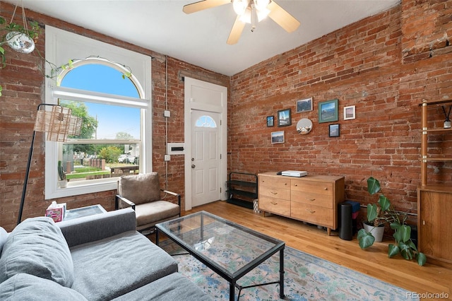 474 N Inca St, Denver, CO 80204 - living room with brick wall, light wood finished floors, and ceiling fan