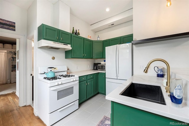 474 N Inca St, Denver, CO 80204 - kitchen featuring white appliances, under cabinet range hood, green cabinetry, and light countertops