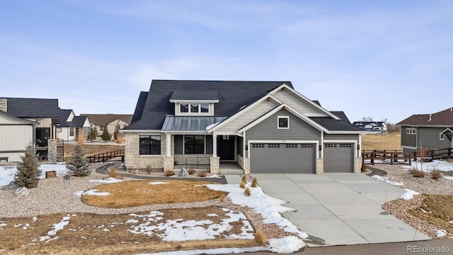 craftsman inspired home with a garage and a porch