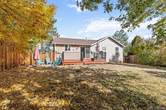 back of house featuring a yard and a wooden deck