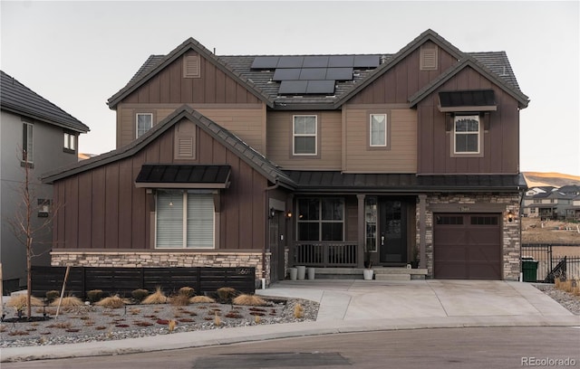 view of front facade featuring a garage and solar panels