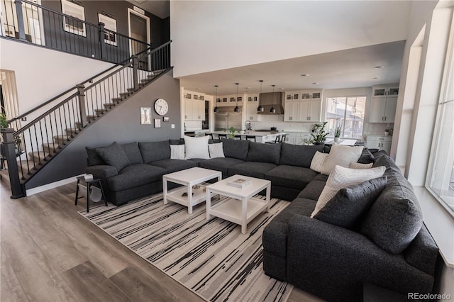 living room featuring light hardwood / wood-style floors and a high ceiling