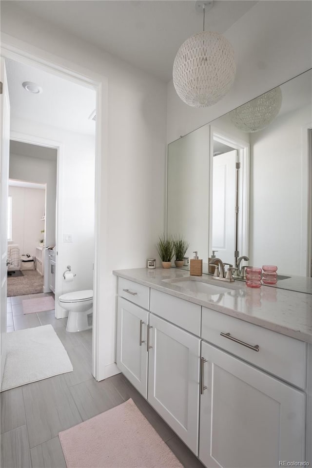 bathroom featuring vanity and toilet