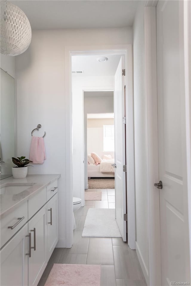 bathroom with vanity, tile patterned floors, and toilet