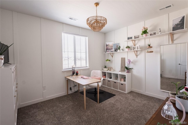 carpeted home office with a chandelier