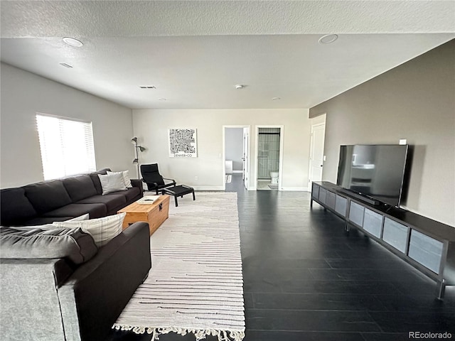 living room with hardwood / wood-style floors and a textured ceiling