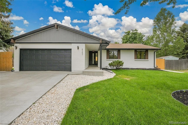 8357 Dudley Ct, Arvada, CO 80005 - ranch-style home featuring a garage, driveway, and brick siding