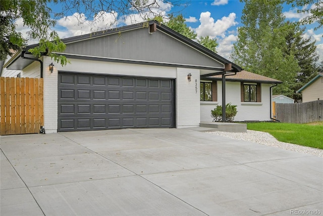 8357 Dudley Ct, Arvada, CO 80005 - single story home featuring brick siding, concrete driveway, and an attached garage