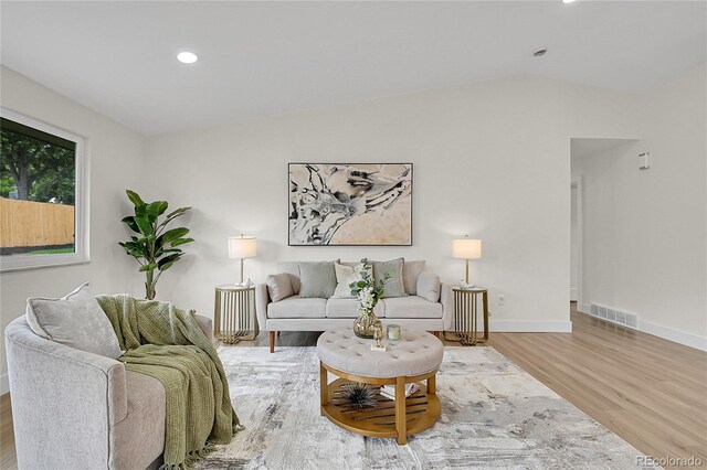 8357 Dudley Ct, Arvada, CO 80005 - living room featuring wood finished floors, lofted ceiling, and recessed lighting