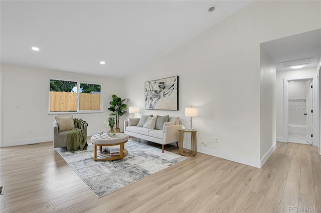8357 Dudley Ct, Arvada, CO 80005 - living room featuring light wood-style floors, vaulted ceiling, attic access, and recessed lighting