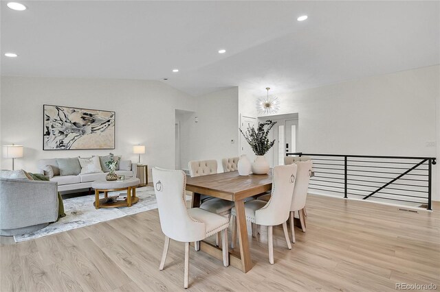 8357 Dudley Ct, Arvada, CO 80005 - dining space with light wood-style floors, lofted ceiling, and recessed lighting