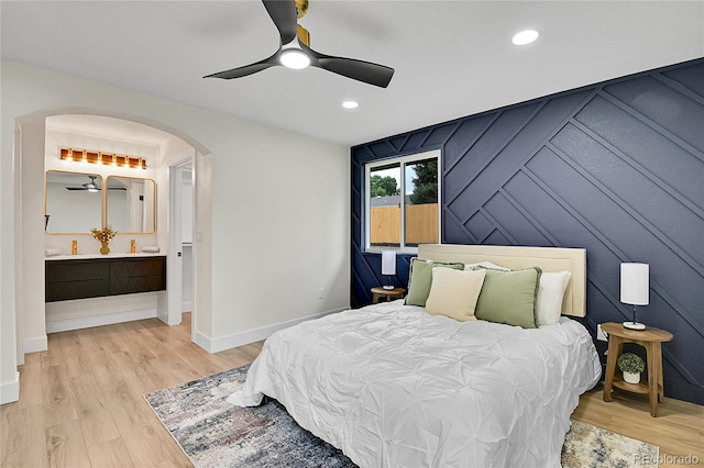 8357 Dudley Ct, Arvada, CO 80005 - bedroom featuring arched walkways, light wood-style floors, recessed lighting, and a ceiling fan