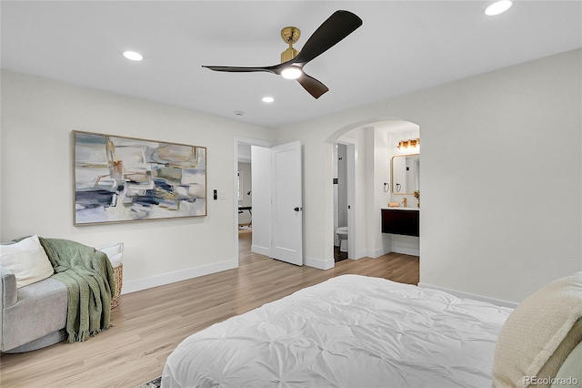 8357 Dudley Ct, Arvada, CO 80005 - bedroom with arched walkways, recessed lighting, wood finished floors, ensuite bath, and ceiling fan