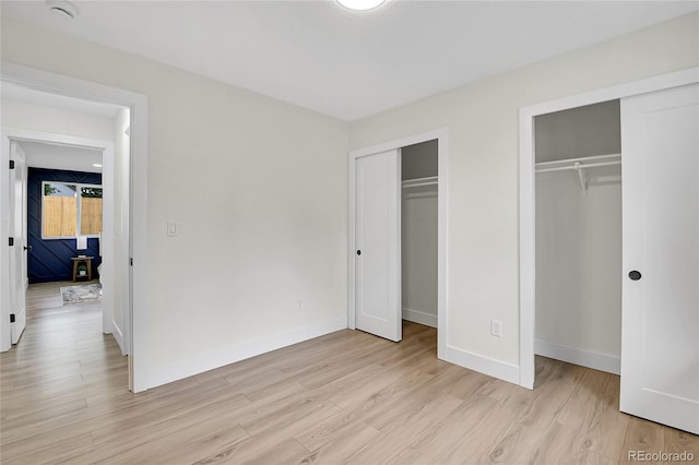 8357 Dudley Ct, Arvada, CO 80005 - unfurnished bedroom featuring multiple closets and light wood finished floors
