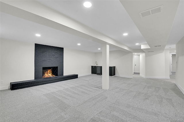 8357 Dudley Ct, Arvada, CO 80005 - finished below grade area with light colored carpet, a fireplace, and recessed lighting