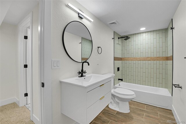 8357 Dudley Ct, Arvada, CO 80005 - full bathroom with vanity, shower / bath combination, wood finish floors, and recessed lighting