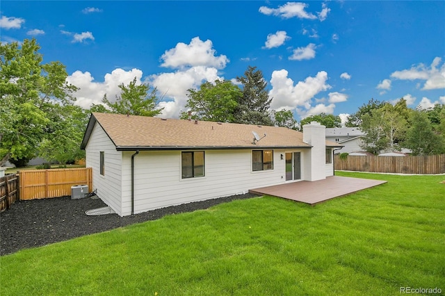 8357 Dudley Ct, Arvada, CO 80005 - rear view of house featuring a fenced backyard, a chimney, and roof with shingles