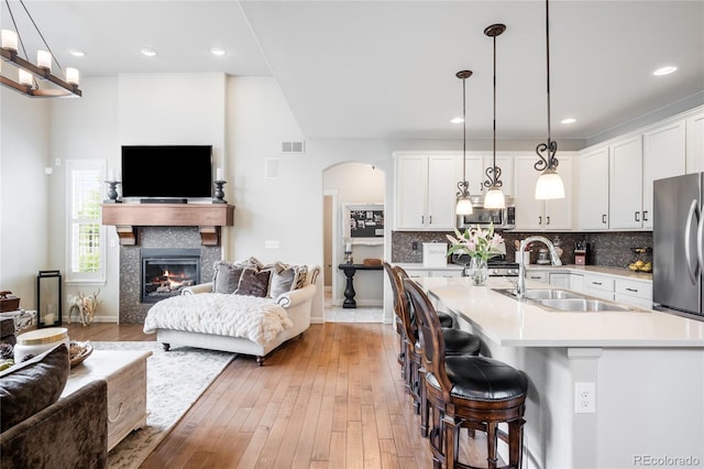 15205 W Baker Ave, Lakewood, CO 80228 - kitchen featuring open floor plan, stainless steel appliances, a sink, light countertops, and recessed lighting