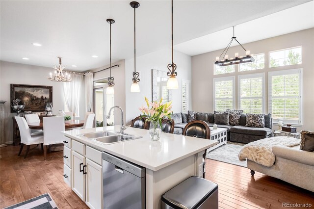 15205 W Baker Ave, Lakewood, CO 80228 - kitchen featuring dishwasher, a chandelier, a sink, open floor plan, and hardwood / wood-style flooring