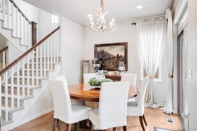 15205 W Baker Ave, Lakewood, CO 80228 - dining space with a chandelier, light wood-style floors, stairs, and recessed lighting