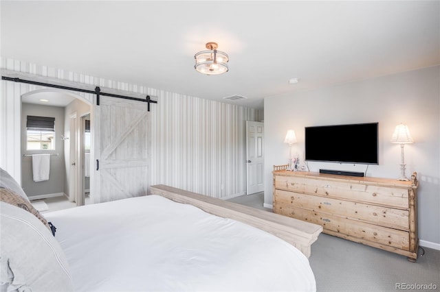 15205 W Baker Ave, Lakewood, CO 80228 - bedroom with a barn door, baseboards, arched walkways, carpet floors, and wallpapered walls