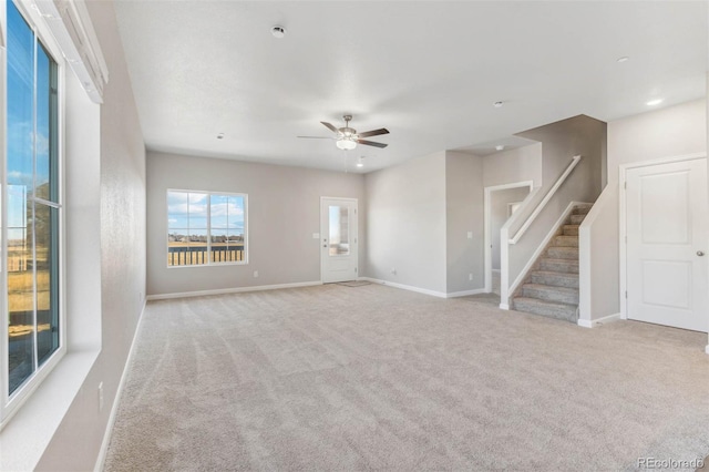 empty room with ceiling fan and light colored carpet