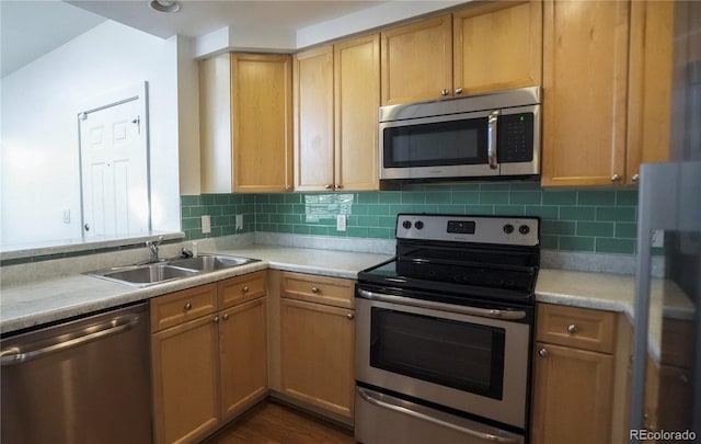 kitchen featuring sink, tasteful backsplash, light brown cabinets, appliances with stainless steel finishes, and dark hardwood / wood-style floors