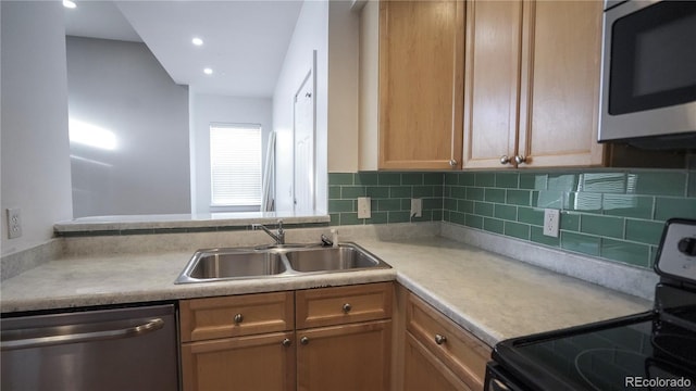 kitchen featuring stainless steel appliances, sink, and backsplash