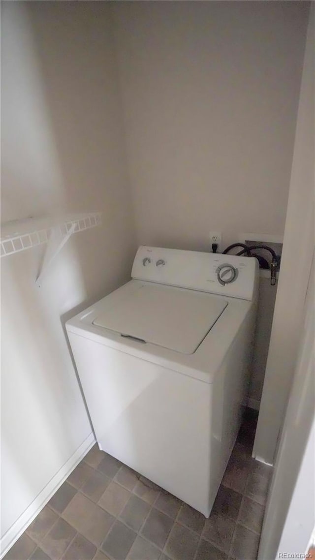 clothes washing area with washer / dryer