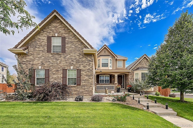 front of property with a front yard and covered porch