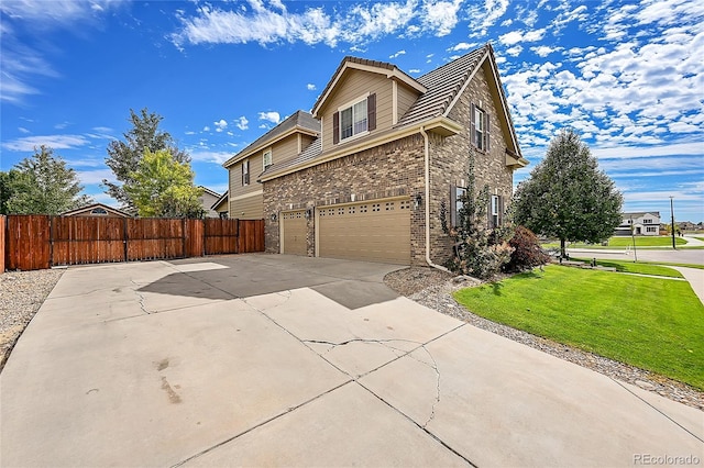 view of home's exterior featuring a garage and a yard