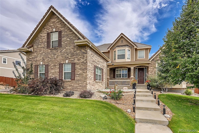 view of front of home featuring a porch and a front lawn