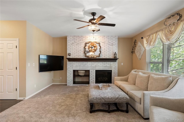 living room with carpet floors, a fireplace, and ceiling fan