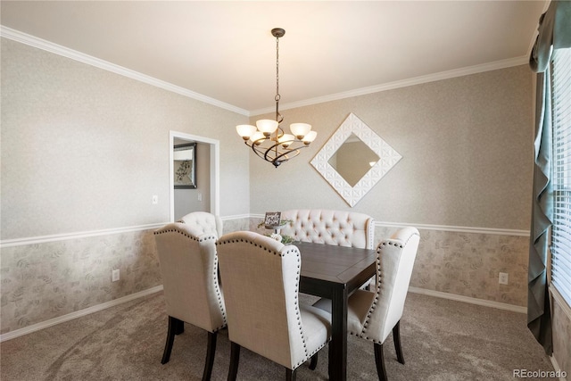 dining room featuring crown molding, carpet flooring, and an inviting chandelier