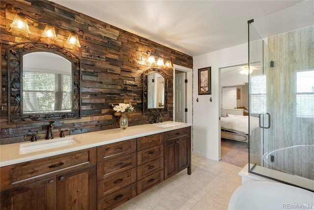 bathroom with walk in shower, tile patterned floors, vanity, and a healthy amount of sunlight