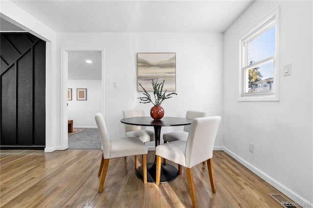 dining space with light wood-type flooring