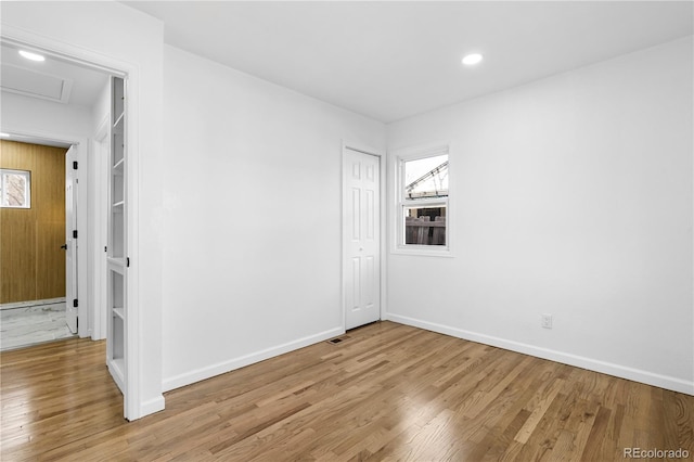 unfurnished room with plenty of natural light and light hardwood / wood-style floors