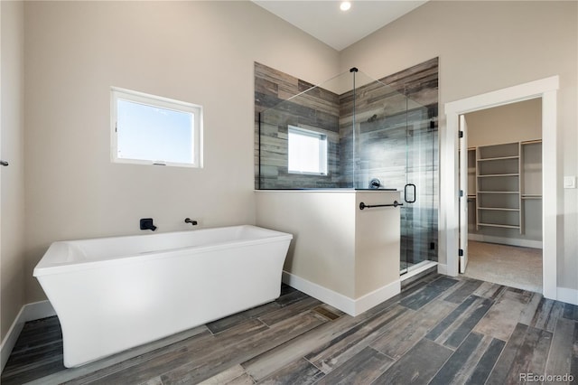 bathroom featuring separate shower and tub