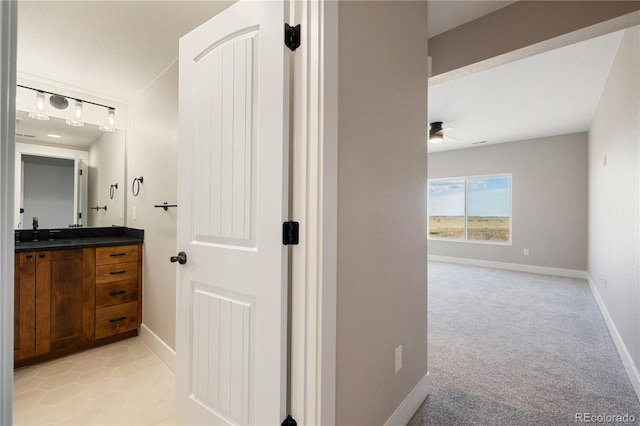 bathroom featuring vanity, tile patterned flooring, and ceiling fan