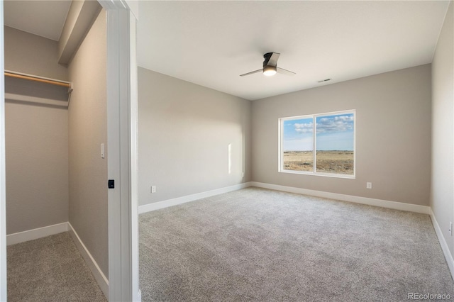 unfurnished bedroom featuring light carpet and ceiling fan