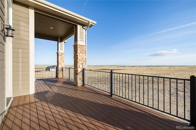 wooden deck featuring a rural view