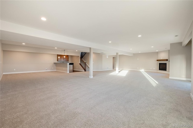 unfurnished living room featuring light colored carpet