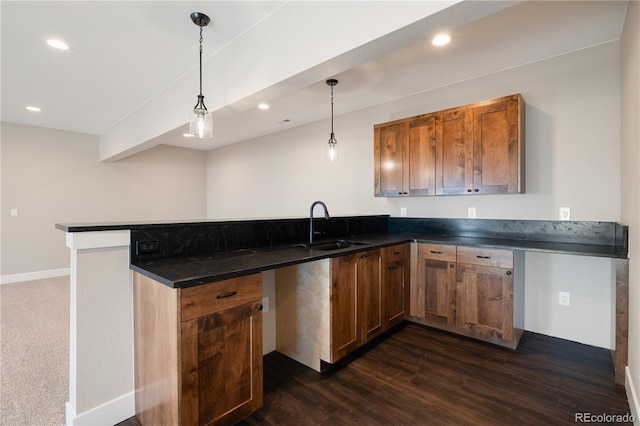 kitchen featuring sink, hanging light fixtures, and kitchen peninsula